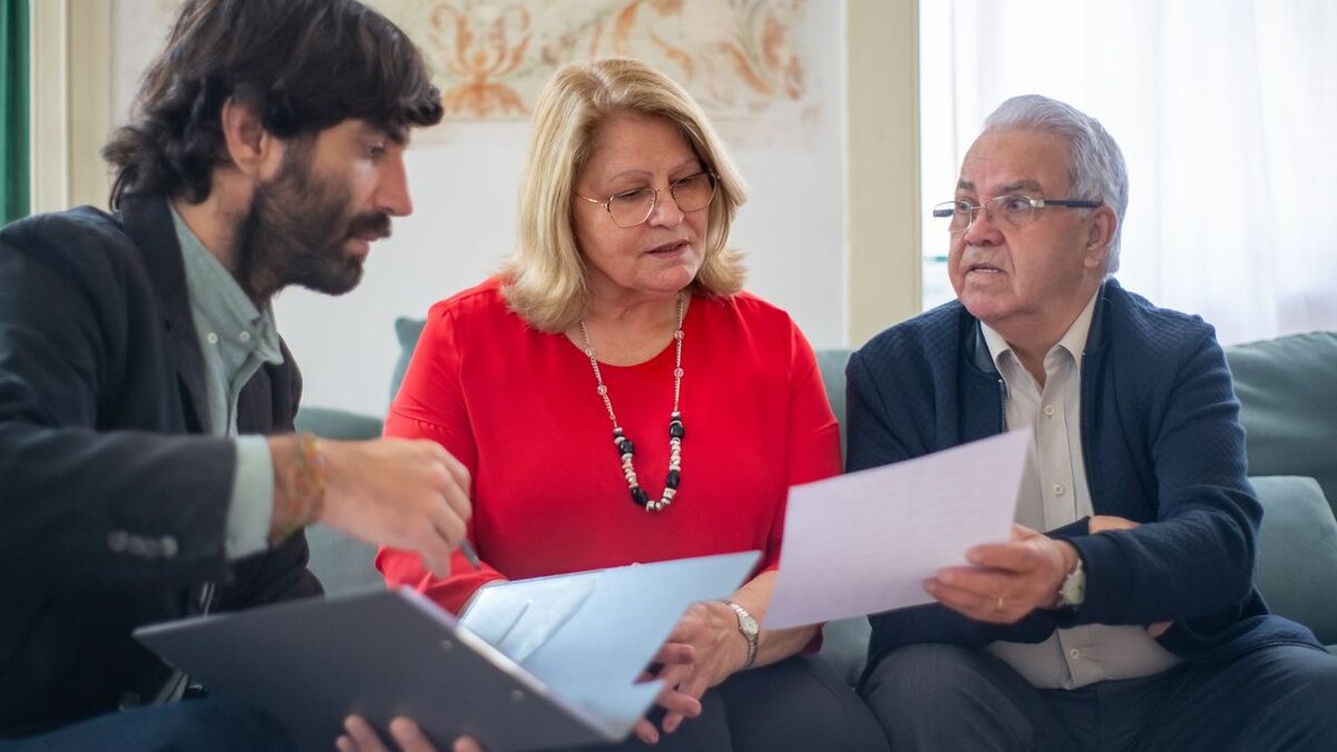 Older couple comparing Medicare options with an advisor