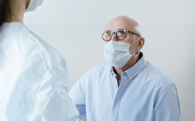 Doctor explaining Medicare parts A B C D to senior patient